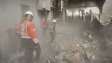 Authorities inspect the site in Gaza after an Israeli air strike killed three people
