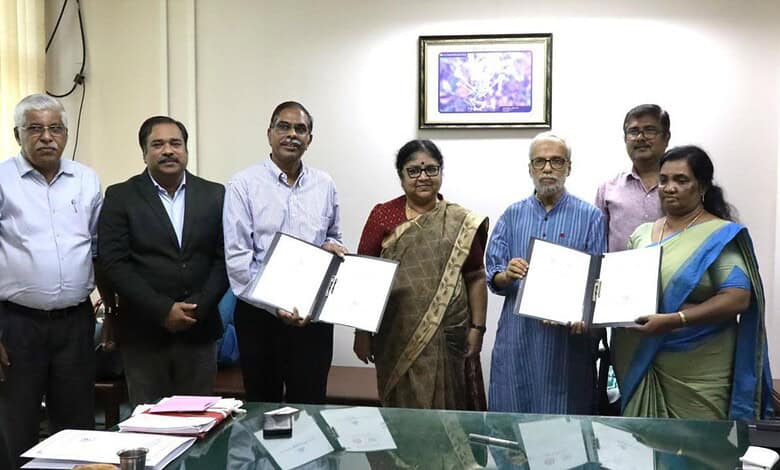 Group of officials holding signed documents during the partnership ceremony.