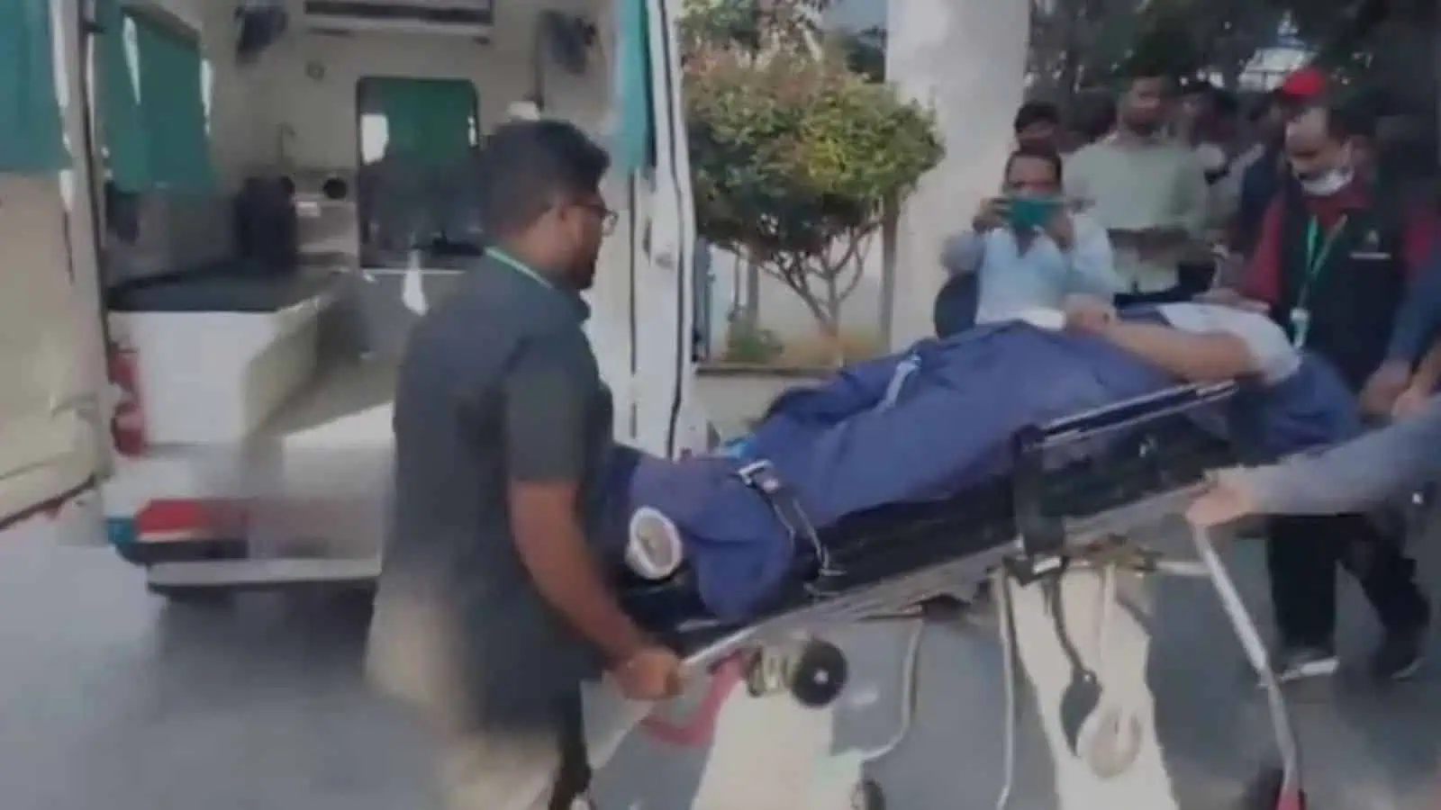 Emergency medical team transports a student on a stretcher at the college campus.
