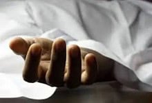 Farmer's hand lying on bed after suicide in Telangana due to debt.
