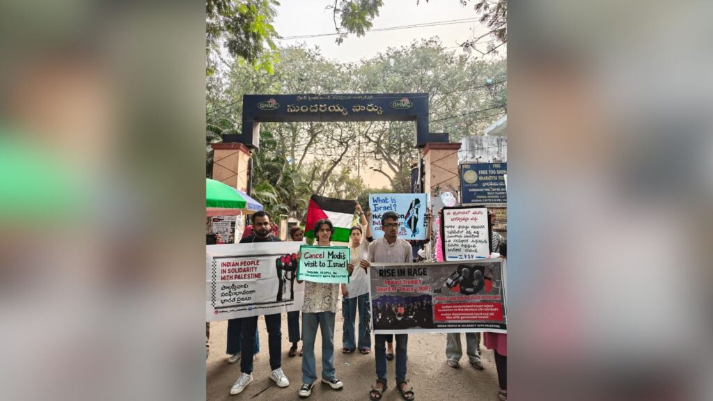 Activists hold signs protesting Trump's peace policies at a rally.