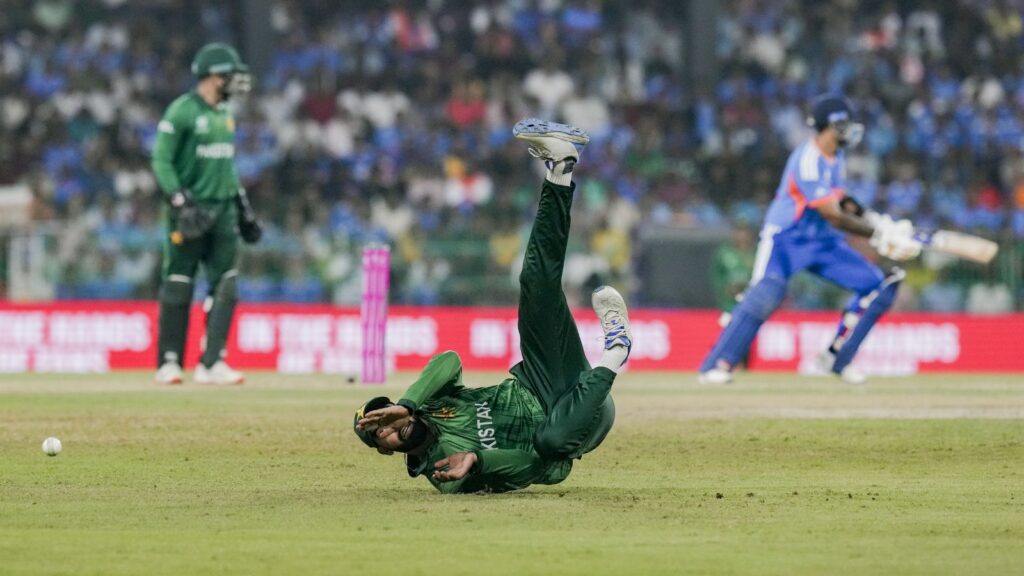 Pakistan cricket player diving on the field during T20 World Cup 2026 match.