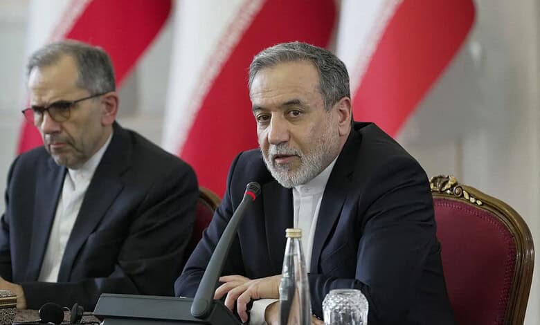 Iranian officials at a conference table during nuclear negotiations in Geneva.