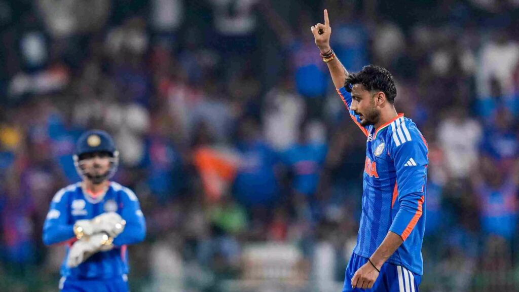 Player celebrating a wicket during a cricket match in blue uniform.