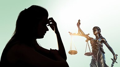 Woman in silhouette holding her head, symbolising confusion and distress in legal cases.