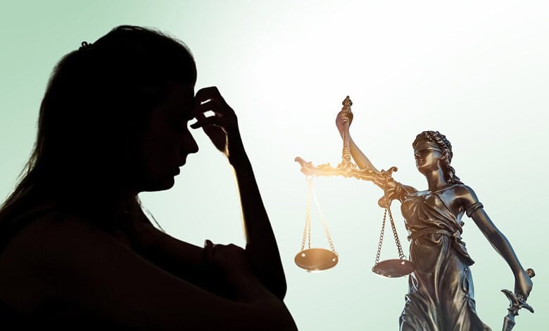 Woman in silhouette holding her head, symbolising confusion and distress in legal cases.