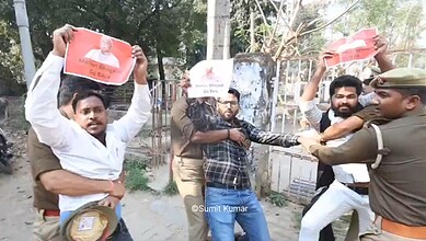 Protesters hold placards during a demonstration at Lucknow University against Mohan Bhagwat's visit, with.