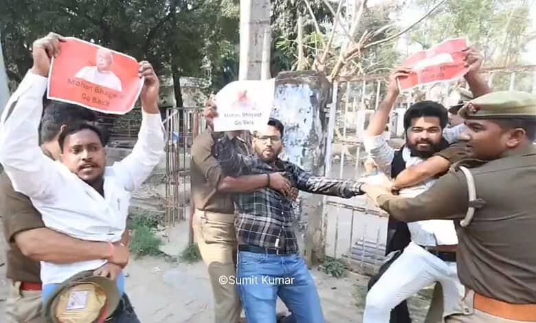 Protesters hold placards during a demonstration at Lucknow University against Mohan Bhagwat's visit, with.