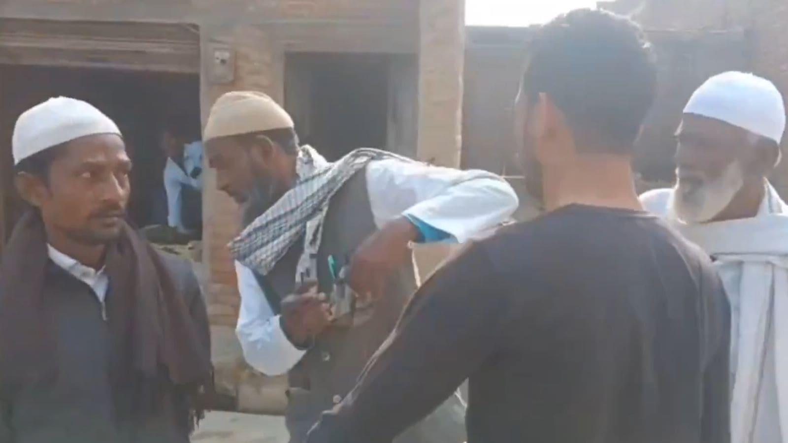 Group of men discussing an incident related to hate crime in Uttar Pradesh, India.