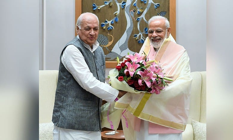 Prime Minister Narendra Modi with Arif Mohammed Khan exchanging greetings during Gujarat visit.