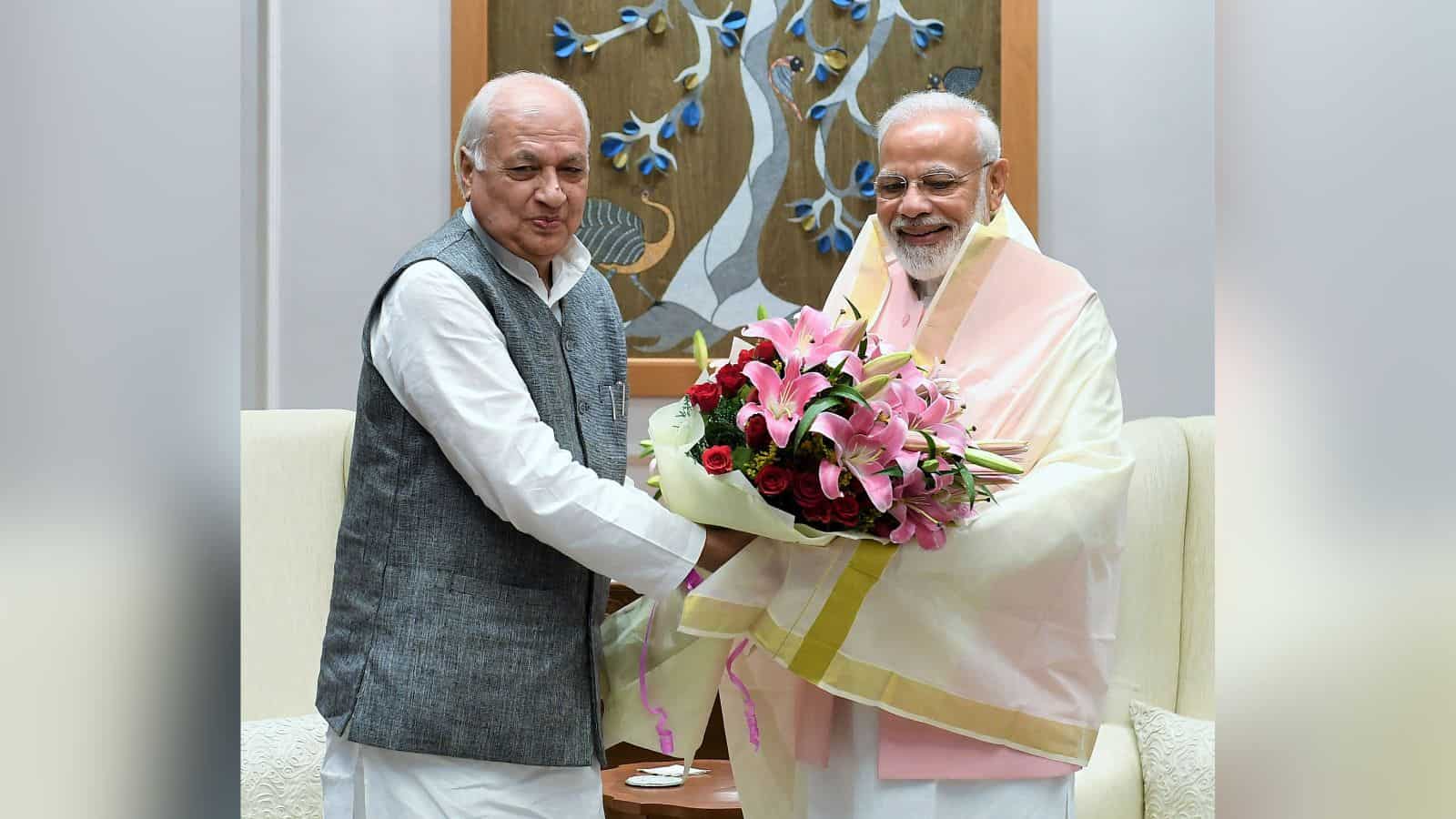 Prime Minister Narendra Modi with Arif Mohammed Khan exchanging greetings during Gujarat visit.