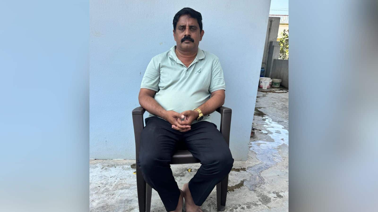 Man sitting outdoors in casual attire at The Siasat Daily office.