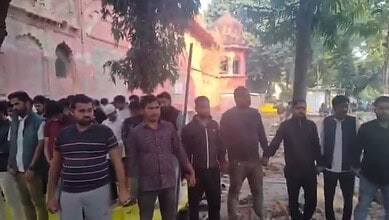 Hindu students holding hands in a human chain during Namaz prayer at Lucknow University, promoting unity.