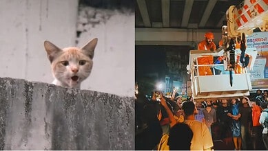 Construction workers operating a crane at night in a busy city setting.