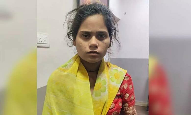 Young girl migrant worker with a serious expression, wearing a yellow and red traditional dress, indoors.