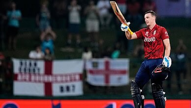 England cricketer celebrating after scoring during T20 World Cup match, advancing to semi-finals.