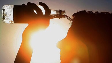 Hydrated person drinking water during Telangana summer heatwave, March 2-7.
