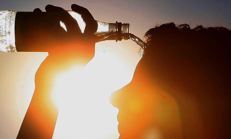 Hydrated person drinking water during Telangana summer heatwave.