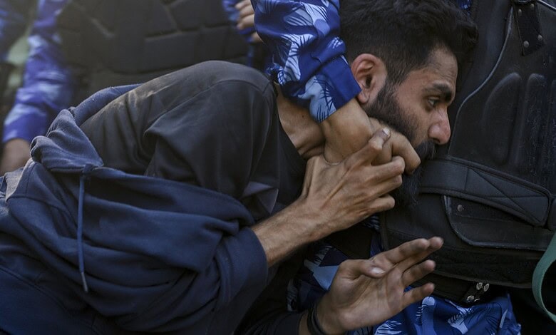A JNU student tackled by police