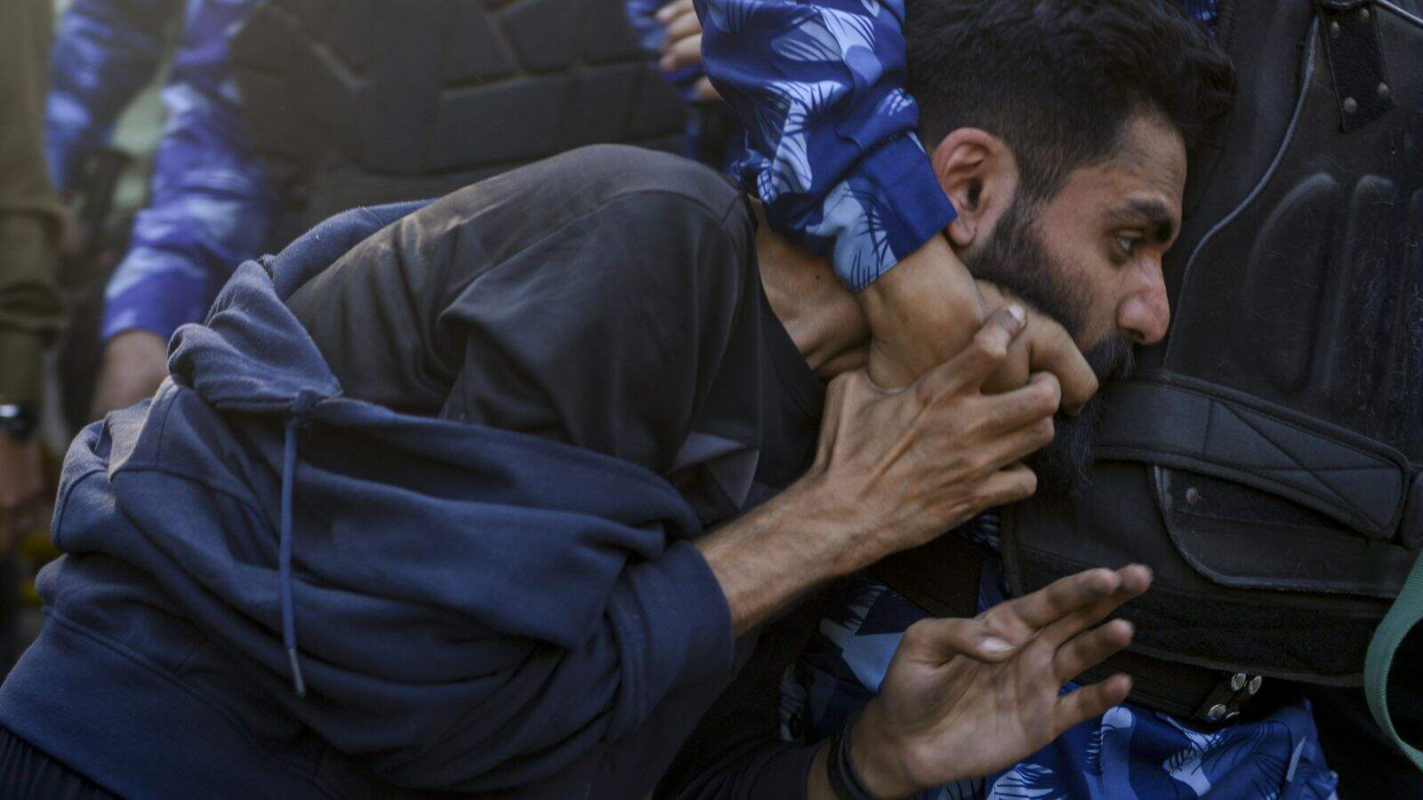 A JNU student tackled by police