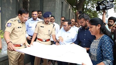 Hyderabad Comissioner of Police V C Sajjanar looks at the map of H-CITI project