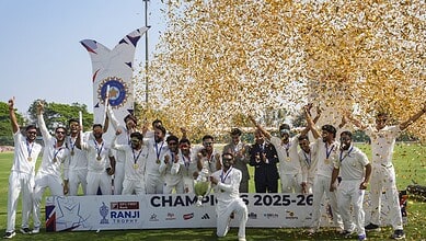 J&K cricket team celebrating their maiden Ranji Trophy victory with players holding medals and a trophy,.