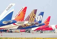 Several commercial airplanes parked on the tarmac with airline logos visible, amid advisories to avoid ce.