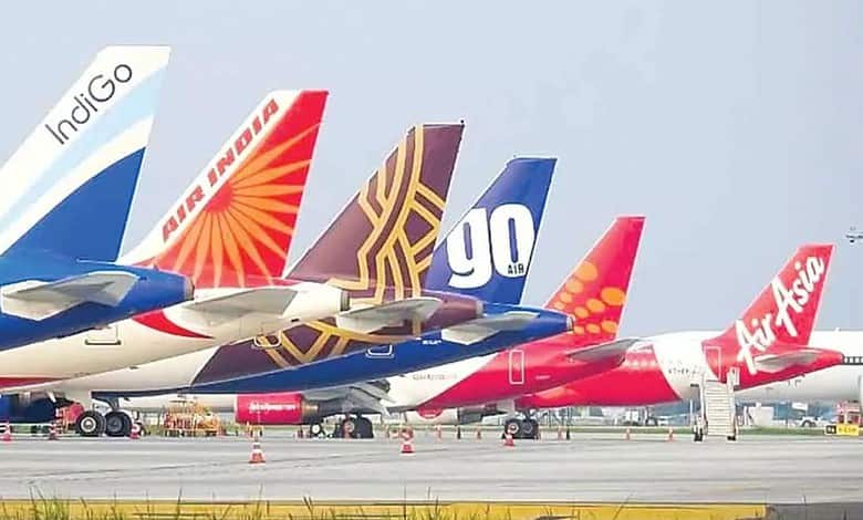 Several commercial airplanes parked on the tarmac with airline logos visible, amid advisories to avoid ce.