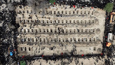 Aerial view of mourners at a cemetery in Iran during a memorial event.