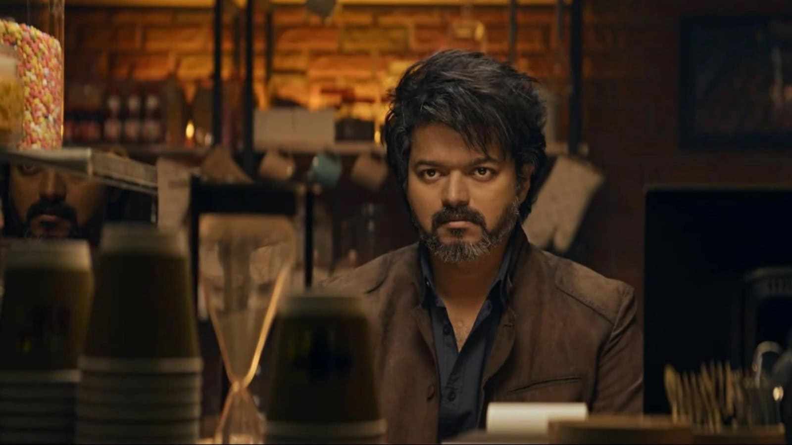 Vijay, the famous Tamil actor, appears in a dramatic scene, reflecting his intense expression and stylish.