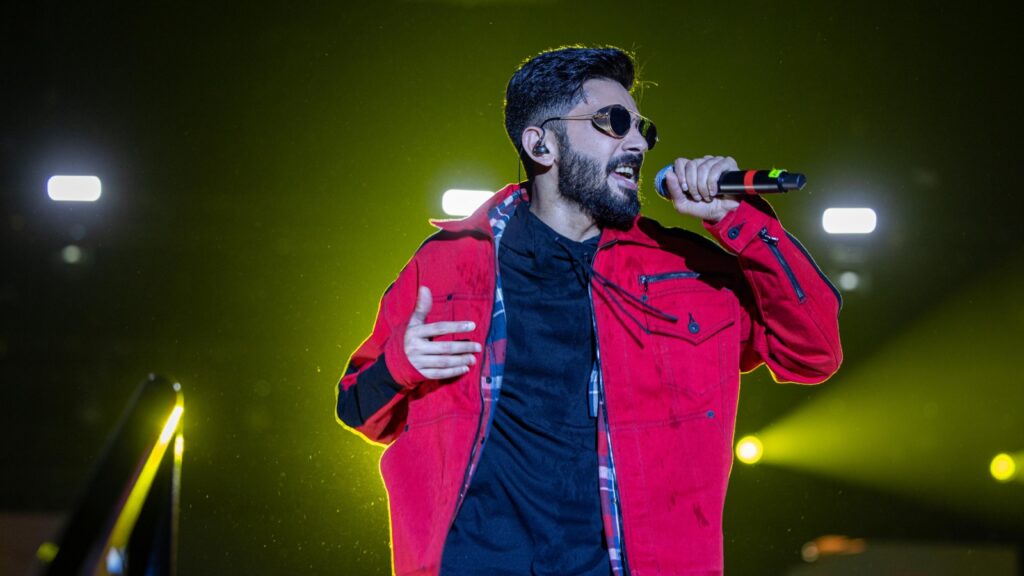 Singer performing at Gachibowli stadium during post-Eid event in Hyderabad.