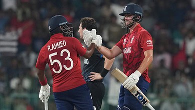 England cricketers R. Ahmed and Rehan celebrate a key wicket in T20 World Cup.
