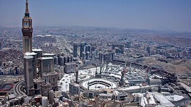 Aerial view of Makkah showing the clock tower and surrounding urban development.