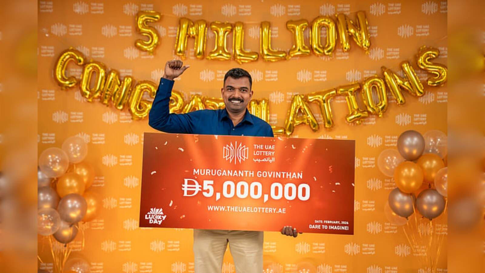 Indian expat Murugananth Govinthan holds cheque after winning Dh 5 million UAE Lottery