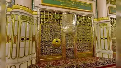 Inner sanctum of Prophet’s Mosque in Madinah featuring intricate gold gates and Islamic decor.