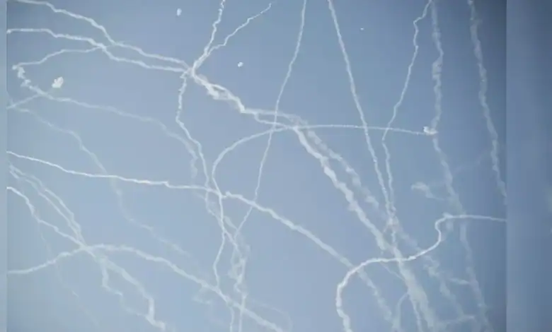 Military jets and missile trails in the sky during Iran's 12-day war.
