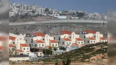 Israeli settlement Neve Yaakov near East Jerusalem, with separation wall dividing Palestinian area in the West Bank.