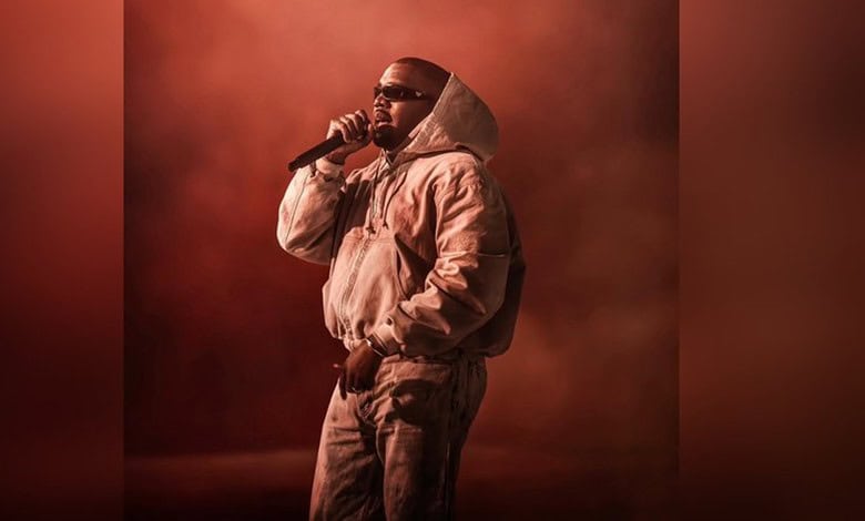 Kanye West on stage during his first-ever performance in India, showcasing his iconic style and musi.