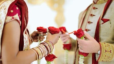 Close-up of bride and groom exchanging floral garlands during wedding ceremony in Hyderabad.