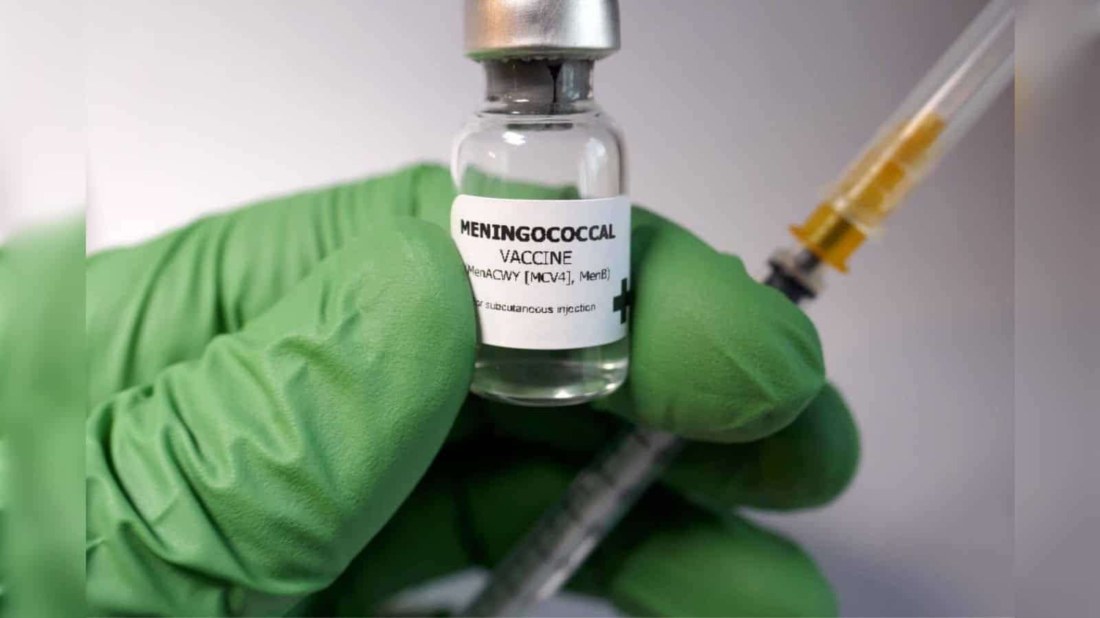 Close-up of meningitis vaccine vial and syringe for Umrah pilgrims' health safety.