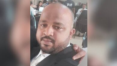 Man with a serious expression, in a crowded setting, related to a stabbing incident.