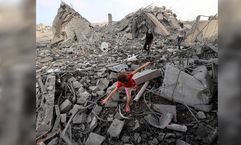 Palestinian girl walks across debris as civilians inspect the rubble of a building destroyed in an Israeli air strike in Bureij refugee camp, central Gaza Strip.