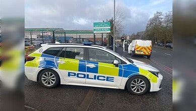 Police car and forensics van outside Oldbury Jamia Masjid in Smethwick, England, where an 18-year-old died after a stabbing.