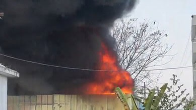 Fire erupts at Sangareddy warehouse causing thick smoke and flames.