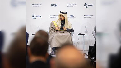 Security conference speaker in traditional Middle Eastern attire speaking at Munich Security Confere.