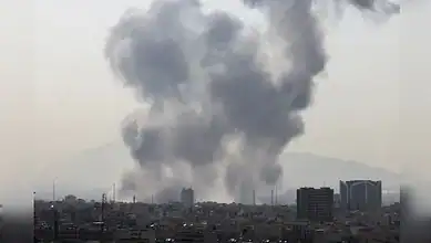 Smoke billows over Tehran skyline after reported US-Israeli airstrikes.