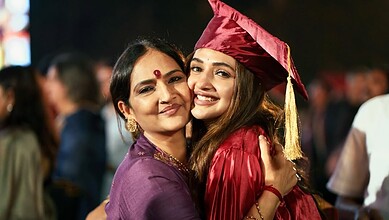 Sreeleela in graduation gown with her mother at her graduation ceremony.