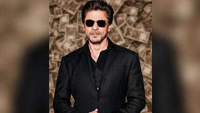 SRK with sunglasses in front of money background, reflecting his financial comeback after losses.