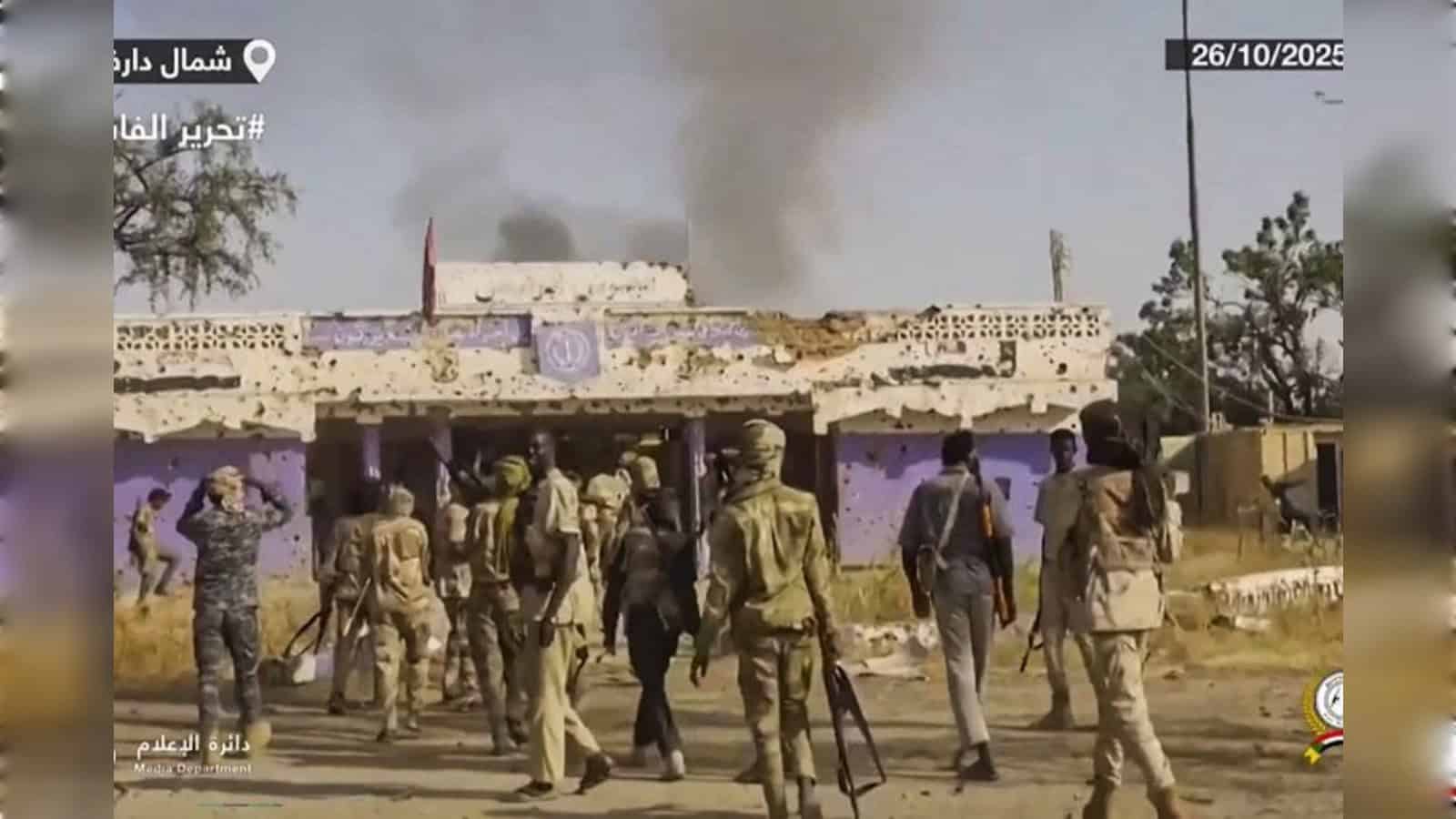 An image showing armed personnel and smoke rising from buildings amid ongoing violence in Sudan.