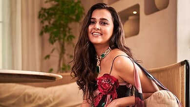 Tejasswi Prakash smiling in her elegant living room, showcasing her Rs 7 crore new home.